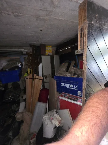 Cluttered garage full of tools, boxes and household items before clearance, typical of jobs we clear in Bournemouth